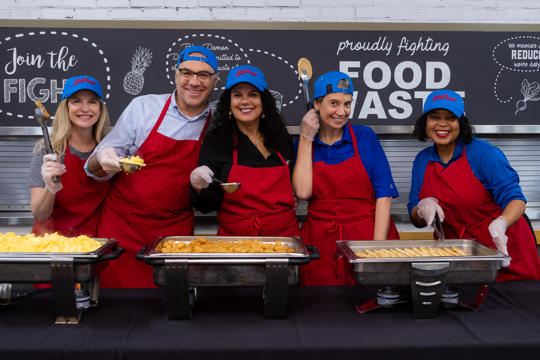 Left to right, Lexa Murphy, GianMario Besana, Salma Ghanem, Lucia Dettori, and Tatum Thomas are ready to serve students at the seventh annual Finals Breakfast on Tuesday, Nov. 14th. (Photo by Jeff Carrion / DePaul University) 